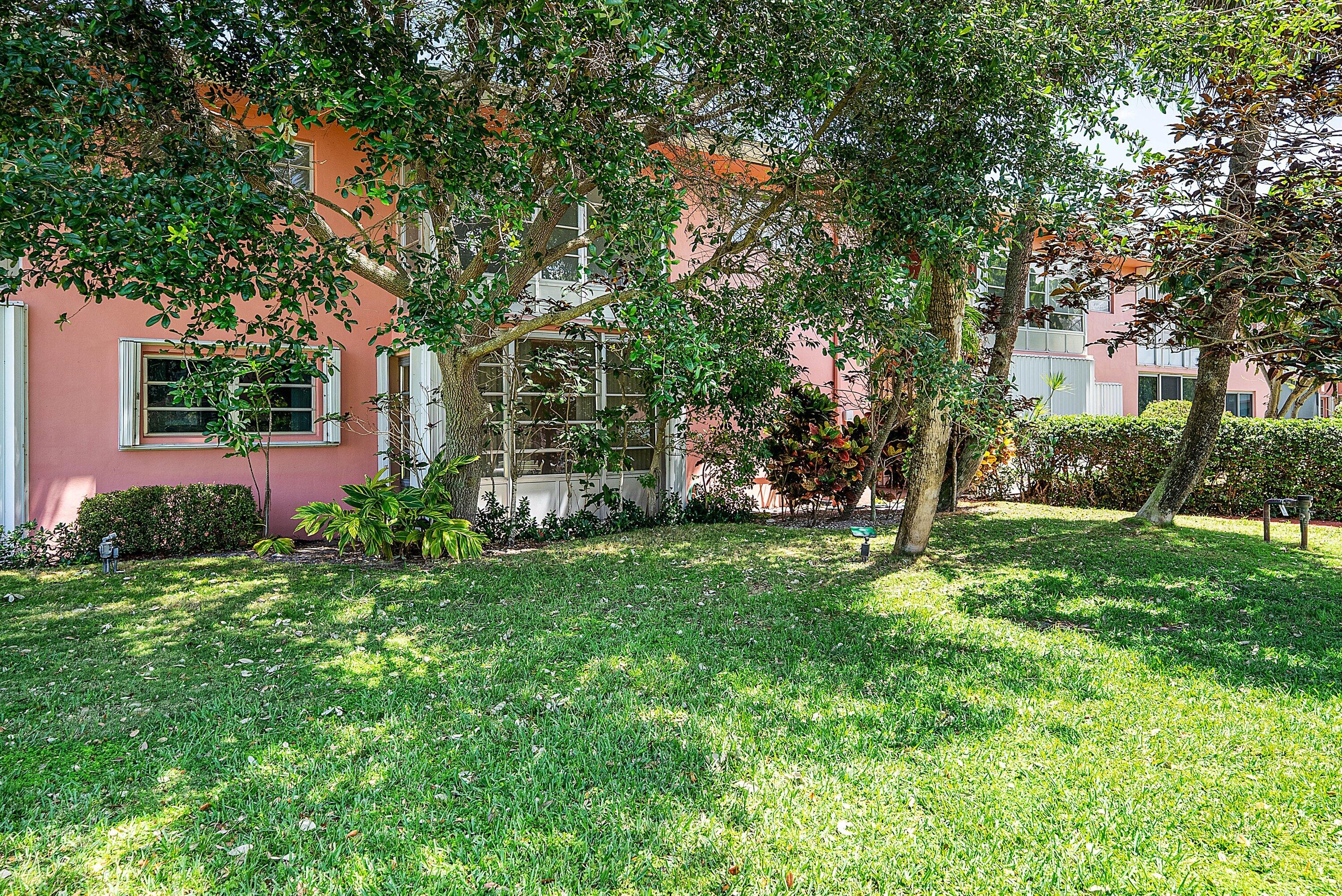 300 Northeast 20th Street, Unit 308 Boca Raton, FL 33431 - Photo 24 of 40 a view of a backyard with plants and large trees