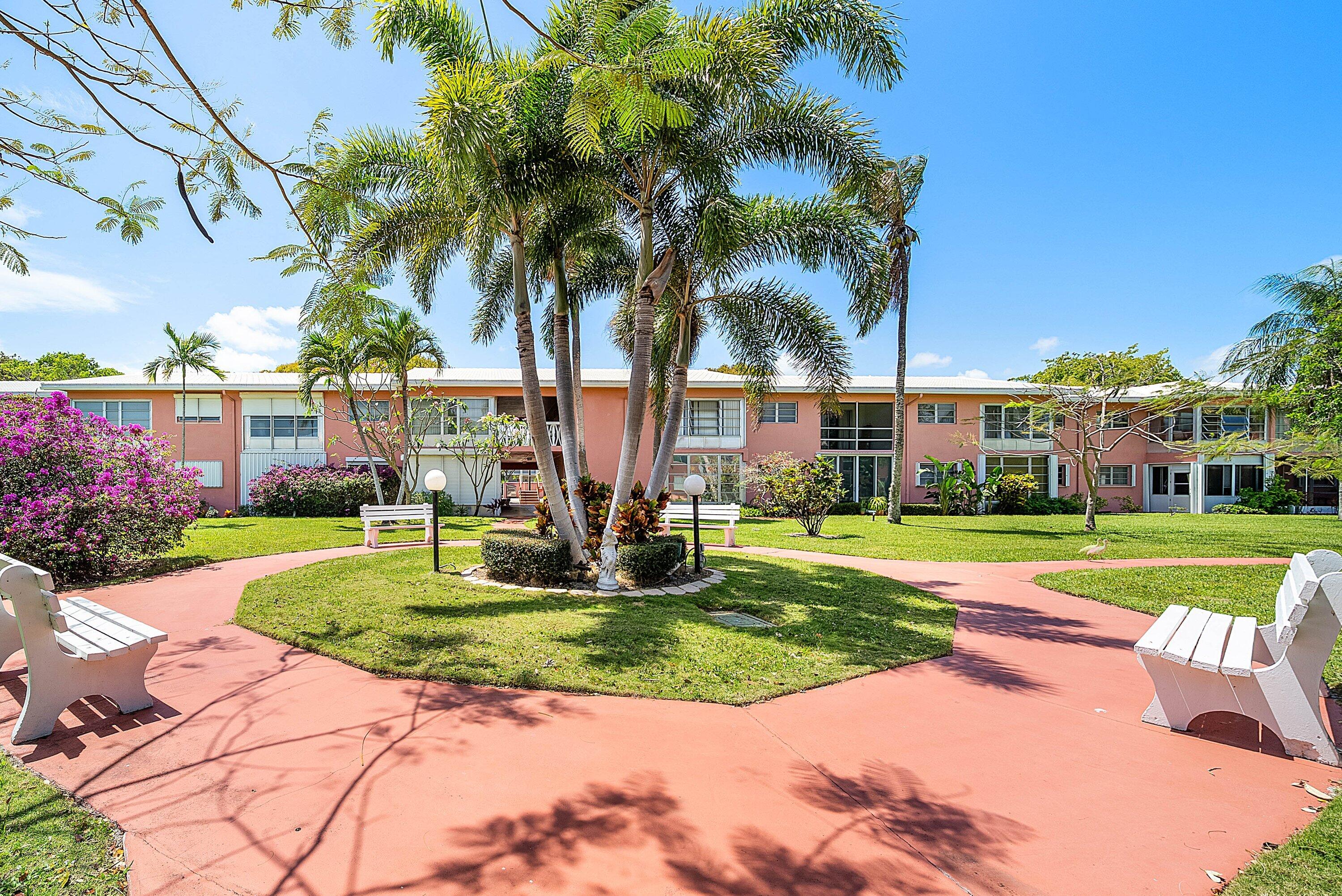 300 Northeast 20th Street, Unit 308 Boca Raton, FL 33431 - Photo 25 of 40 a view of a swimming pool with a house