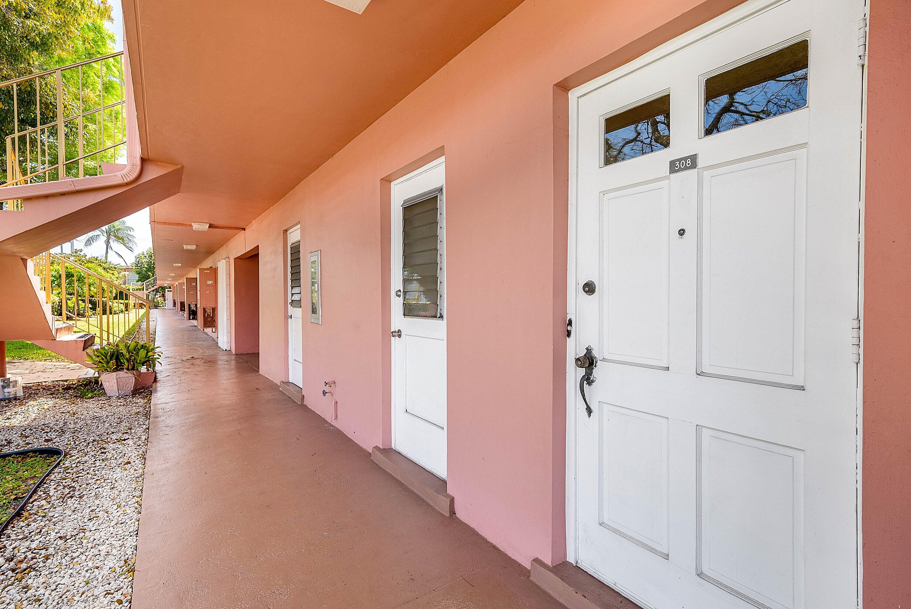 300 Northeast 20th Street, Unit 308 Boca Raton, FL 33431 - Photo 4 of 40 a view of a hallway with wooden floor and windows