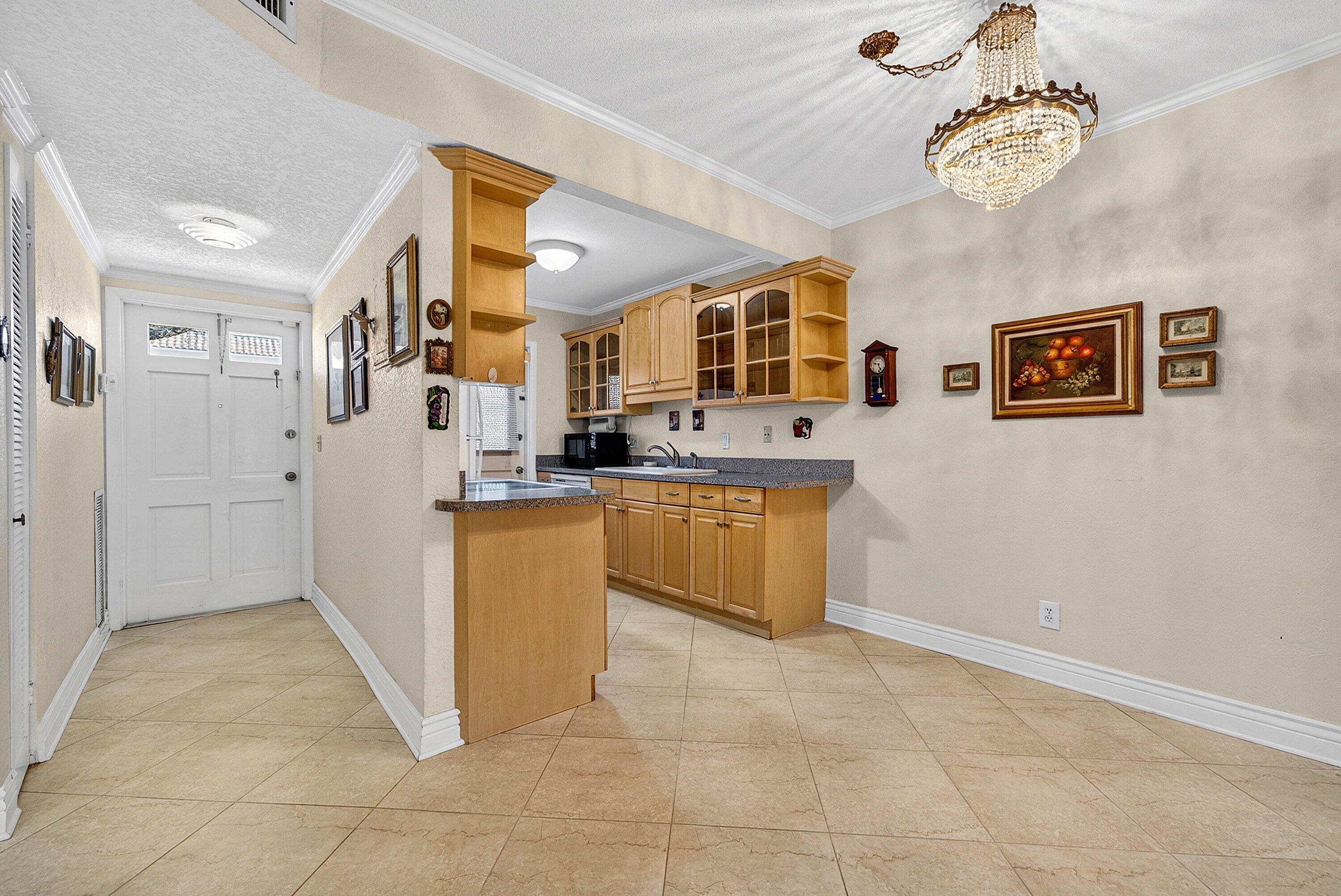 300 Northeast 20th Street, Unit 308 Boca Raton, FL 33431 - Photo 5 of 40 a kitchen with stainless steel appliances granite countertop a refrigerator and a sink