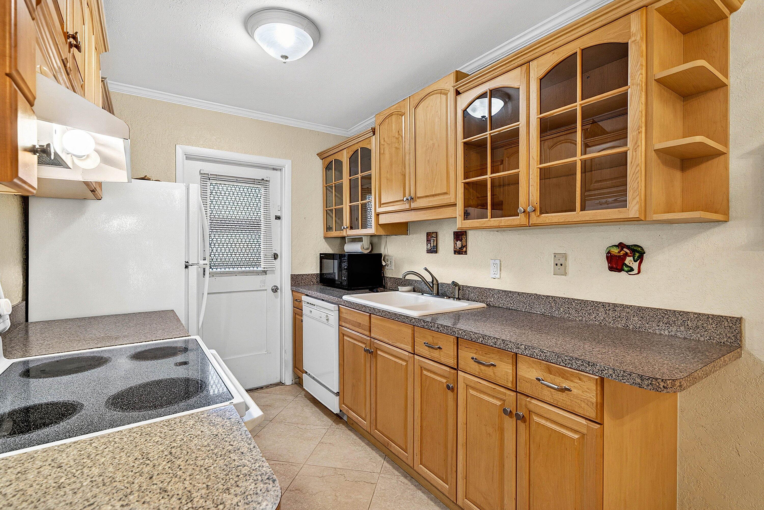 300 Northeast 20th Street, Unit 308 Boca Raton, FL 33431 - Photo 7 of 40 a kitchen with stainless steel appliances granite countertop a stove and a sink