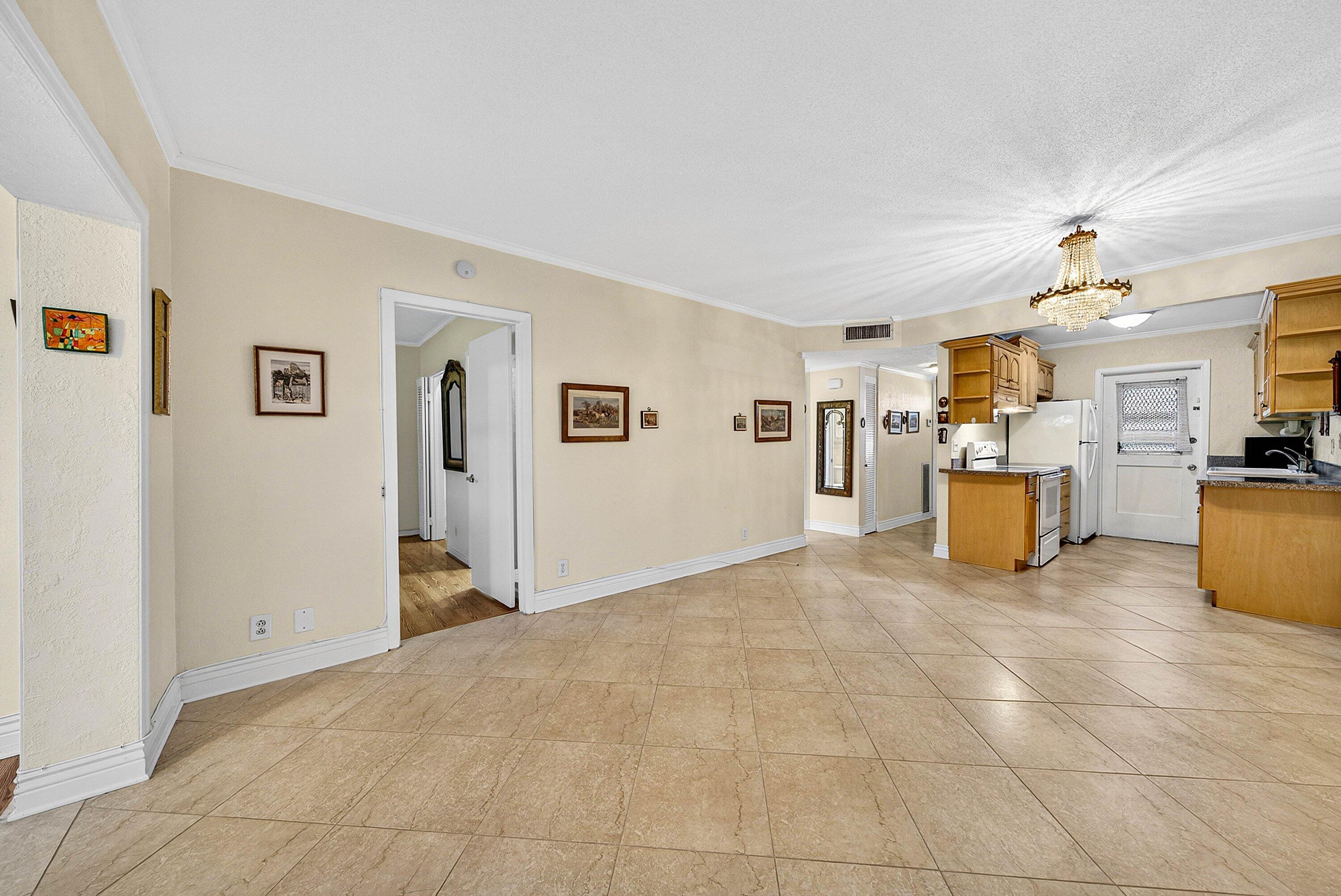 300 Northeast 20th Street, Unit 308 Boca Raton, FL 33431 - Photo 10 of 40 a view of a livingroom with furniture and a kitchen