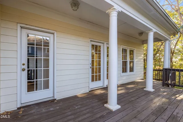 an entrance view with wooden floor and windows