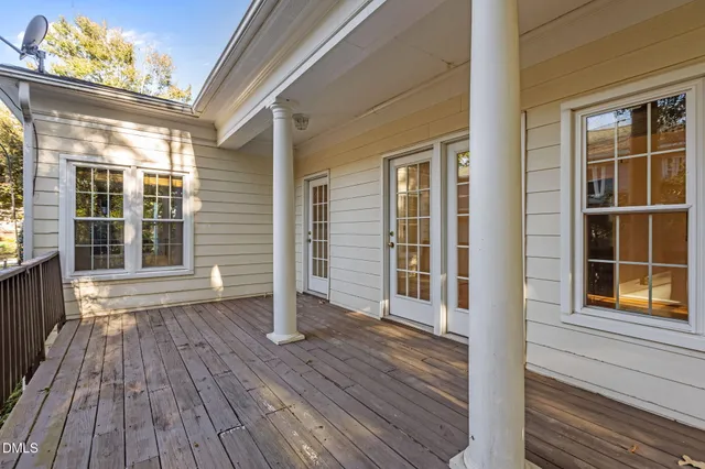 a view of outdoor space with wooden floor and windows