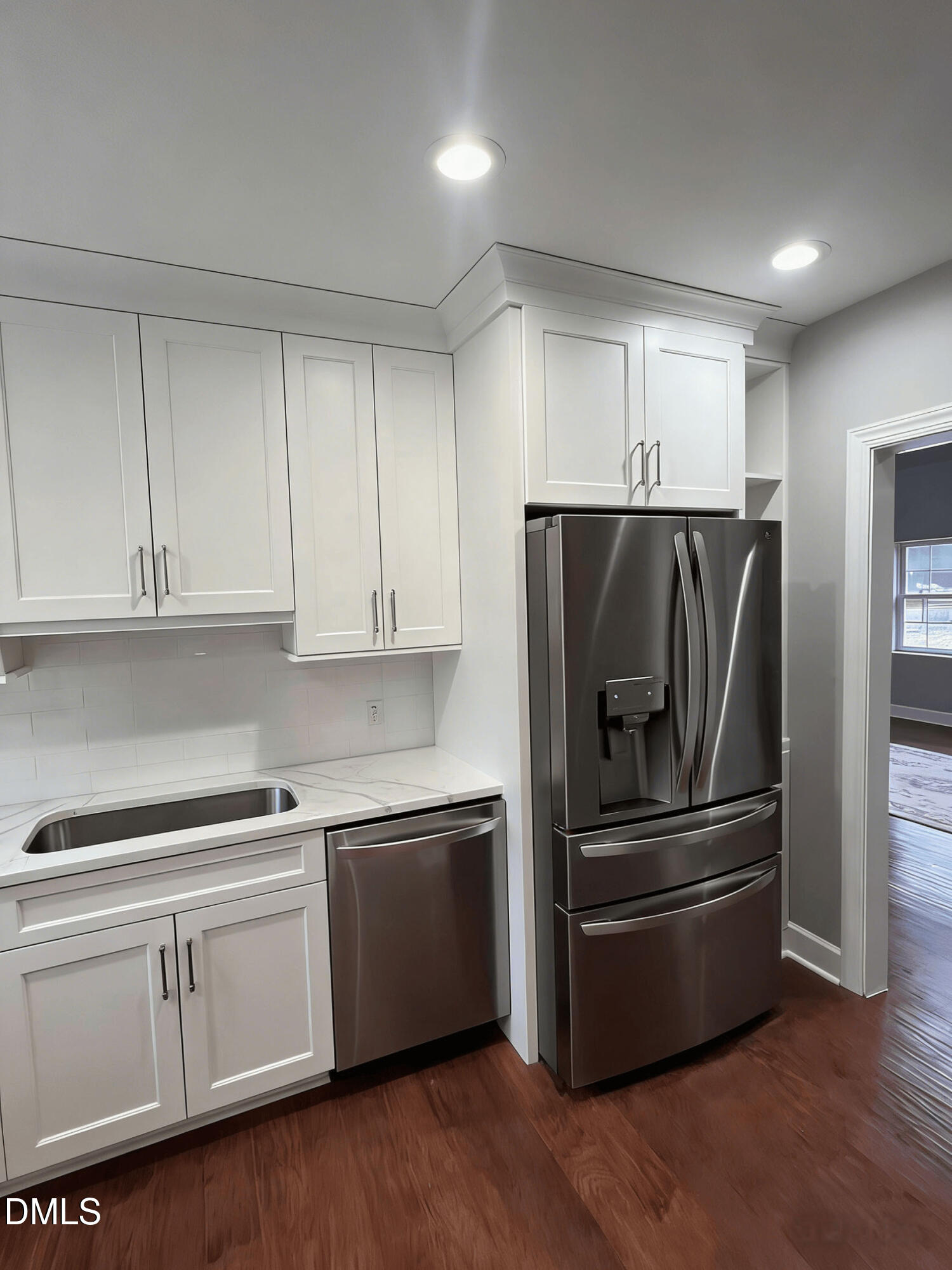 409 Rockingham Street Carthage, NC 28327 - Photo 14 of 56 a kitchen with white cabinets and stainless steel appliances