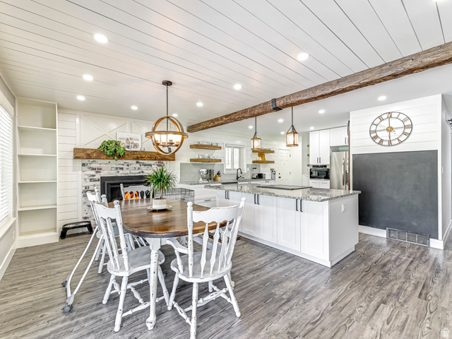 523 South Main Street Payson, UT 84651 - Photo 14 of 41 Spacious open-concept living area featuring wood-finish flooring and a shiplap ceiling with an exposed wood beam