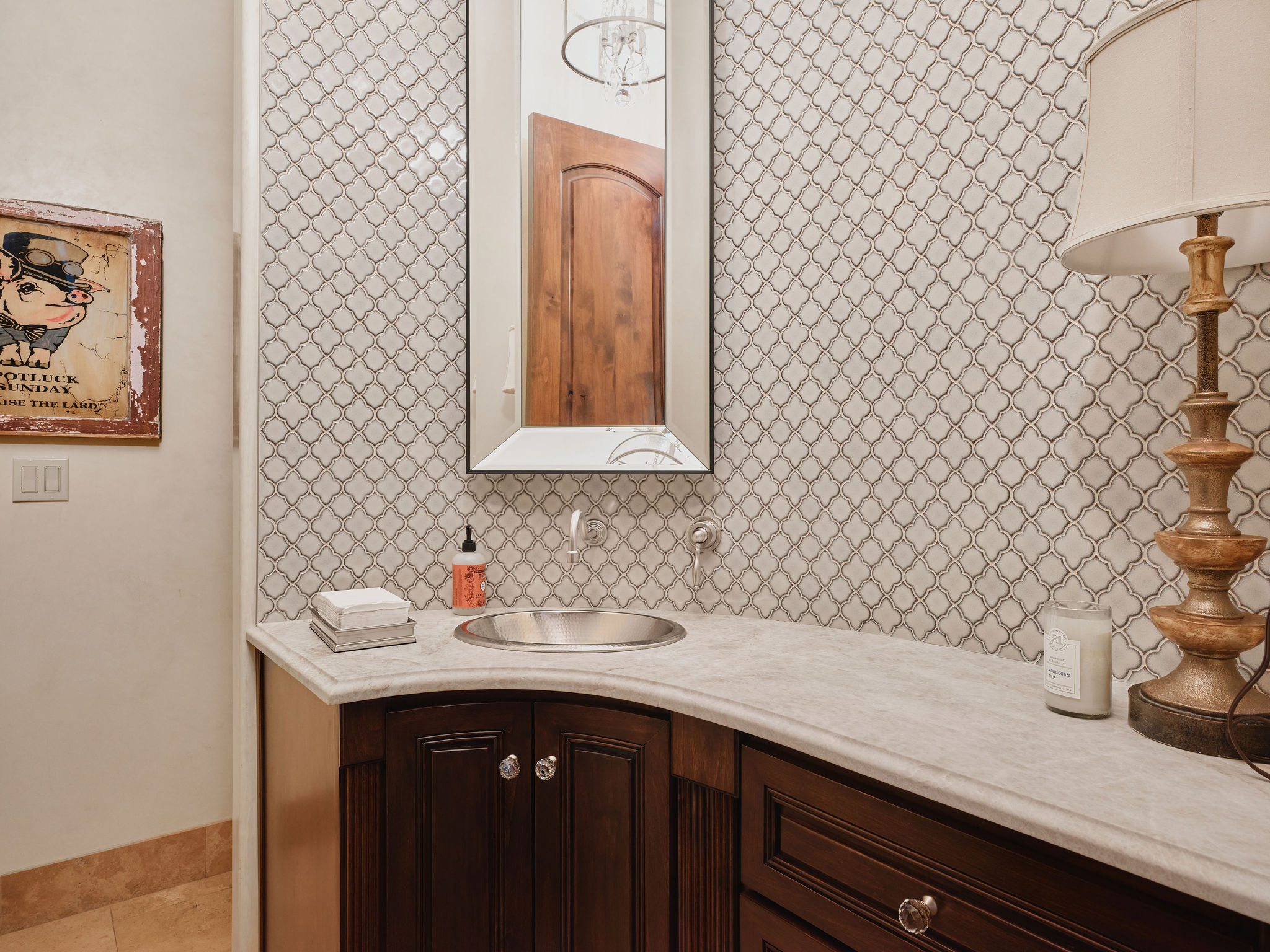433 Brandon Way Austin, TX 78733 - Photo 31 of 40 Elegant powder room featuring intricate mosaic tile backsplash and a sophisticated vanity with ample storage.
