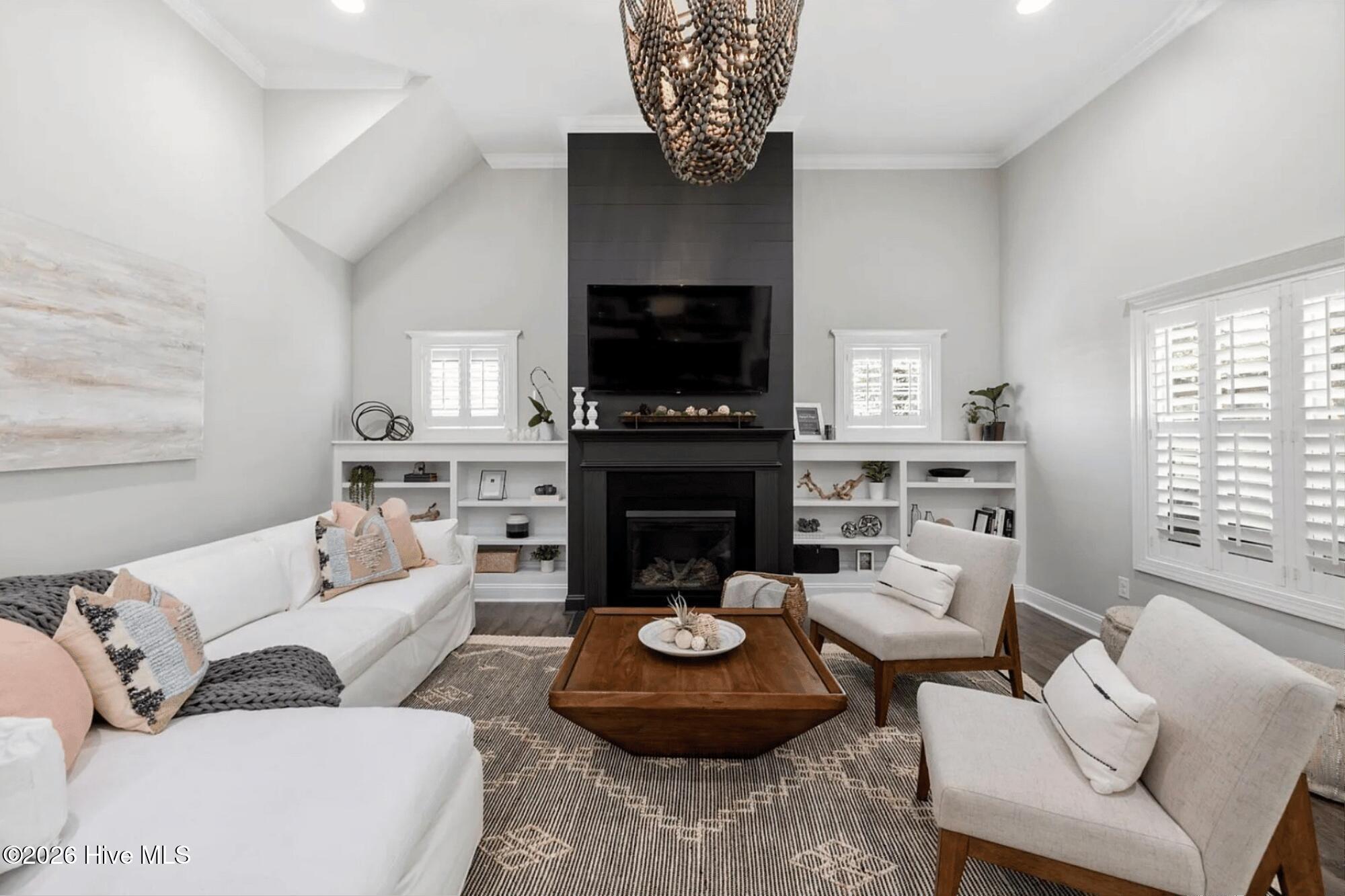 88 South Lamplighters Walk Hampstead, NC 28443 - Photo 2 of 34 Expansive and bright Living Room with Designer Lighting, Iron Ore Shiplap enhanced Fireplace, Built-in Shelves and Plantation Shutters throughout.