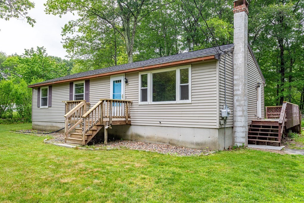 a view of a house with a yard and a patio