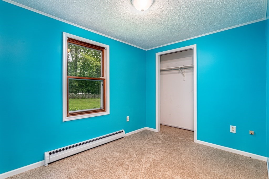 123 Dunn Road Ashburnham, MA 01430 - Photo 14 of 42 a view of an empty room with a window and a fan