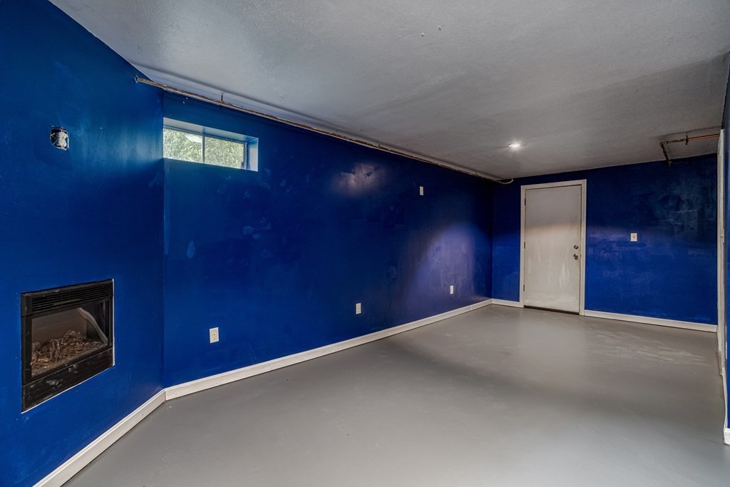 123 Dunn Road Ashburnham, MA 01430 - Photo 32 of 42 a view of an empty room with a fireplace
