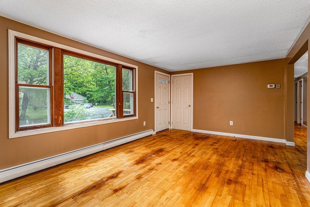 123 Dunn Road Ashburnham, MA 01430 - Photo 6 of 42 a view of an empty room with a window