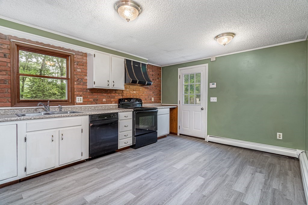123 Dunn Road Ashburnham, MA 01430 - Photo 8 of 42 a kitchen with a sink wooden floor and a window