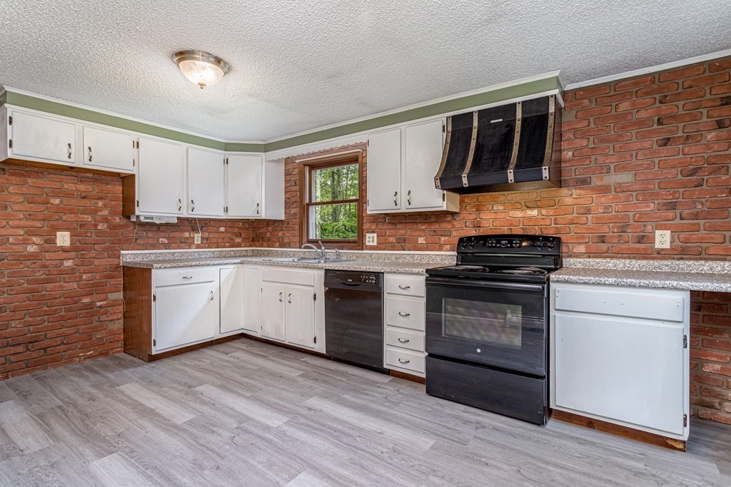 123 Dunn Road Ashburnham, MA 01430 - Photo 9 of 42 a kitchen with stainless steel appliances a stove top oven