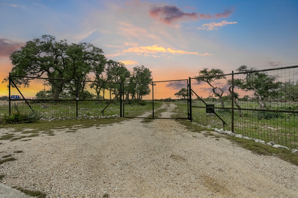 181 Real Lake House Road South Kerrville, TX 78028 - Photo 14 of 18 a view of a street with a yard