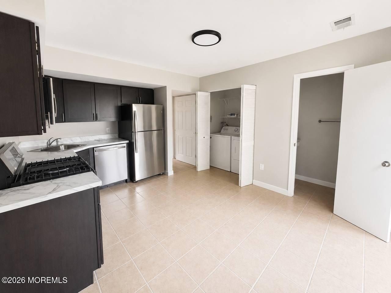 1144 Sawmill Road, Unit 121 Brick, NJ 08724 - Photo 11 of 23 a kitchen with stainless steel appliances a refrigerator and a stove