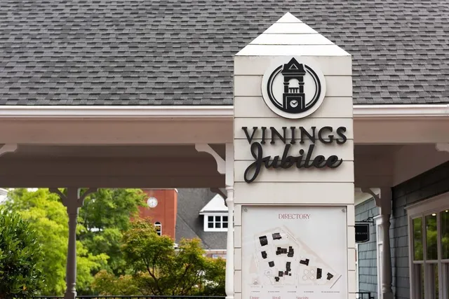 a view of a house with a yard and large tree