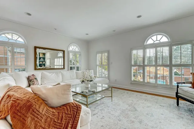a spacious bedroom with a bed and glass window