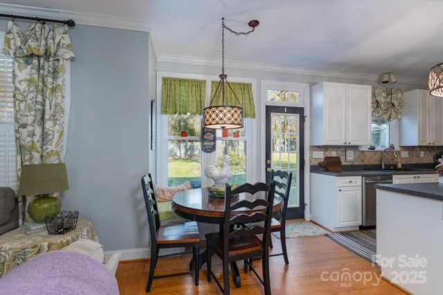 a kitchen with a table chairs and a dining table