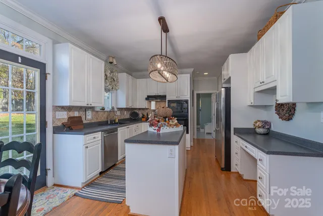 a kitchen with sink refrigerator and window