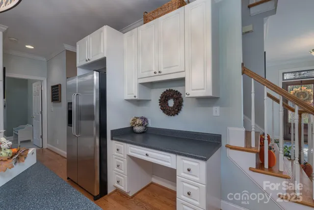 a kitchen with a refrigerator and a stove top oven