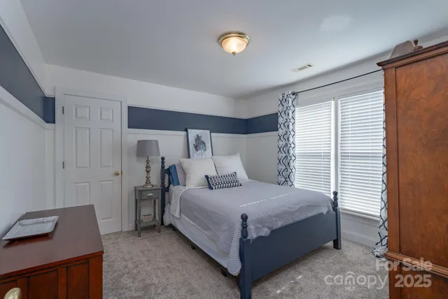 a bedroom with a bed and a desk in it