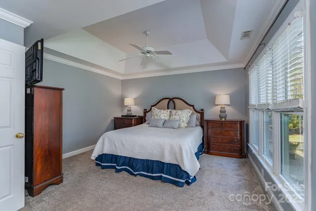 a bedroom with a bed and a chandelier