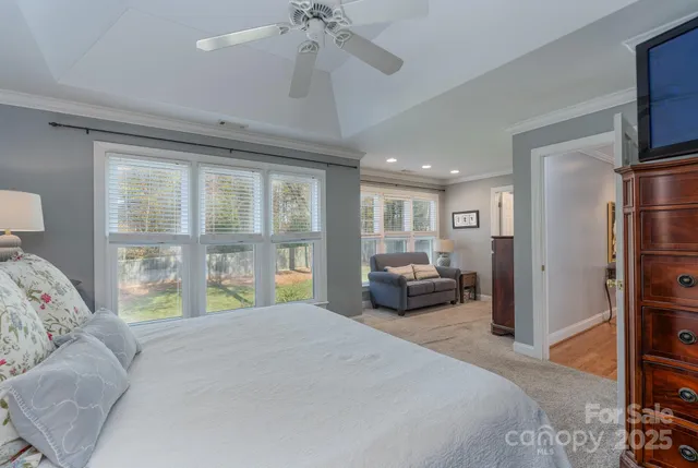 a bedroom with a large bed and a chandelier