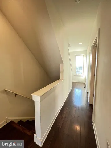 a view of hallway with wooden floor