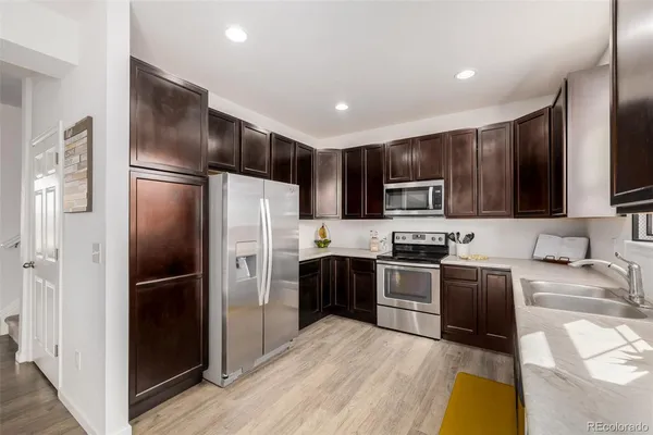 a kitchen with granite countertop stainless steel appliances and wooden cabinets