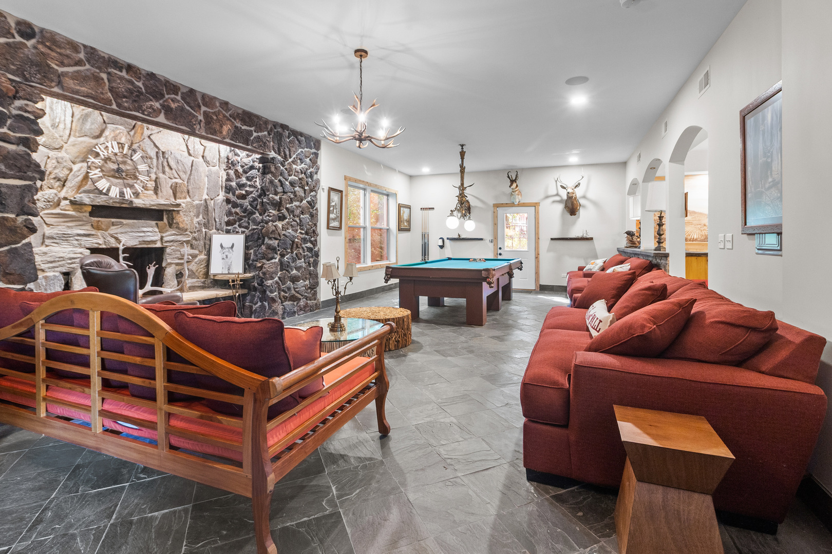 7830 North Pillow Hill Road Spring Grove, IL 60081 - Photo 16 of 69 a living room with furniture a chandelier and a dining table