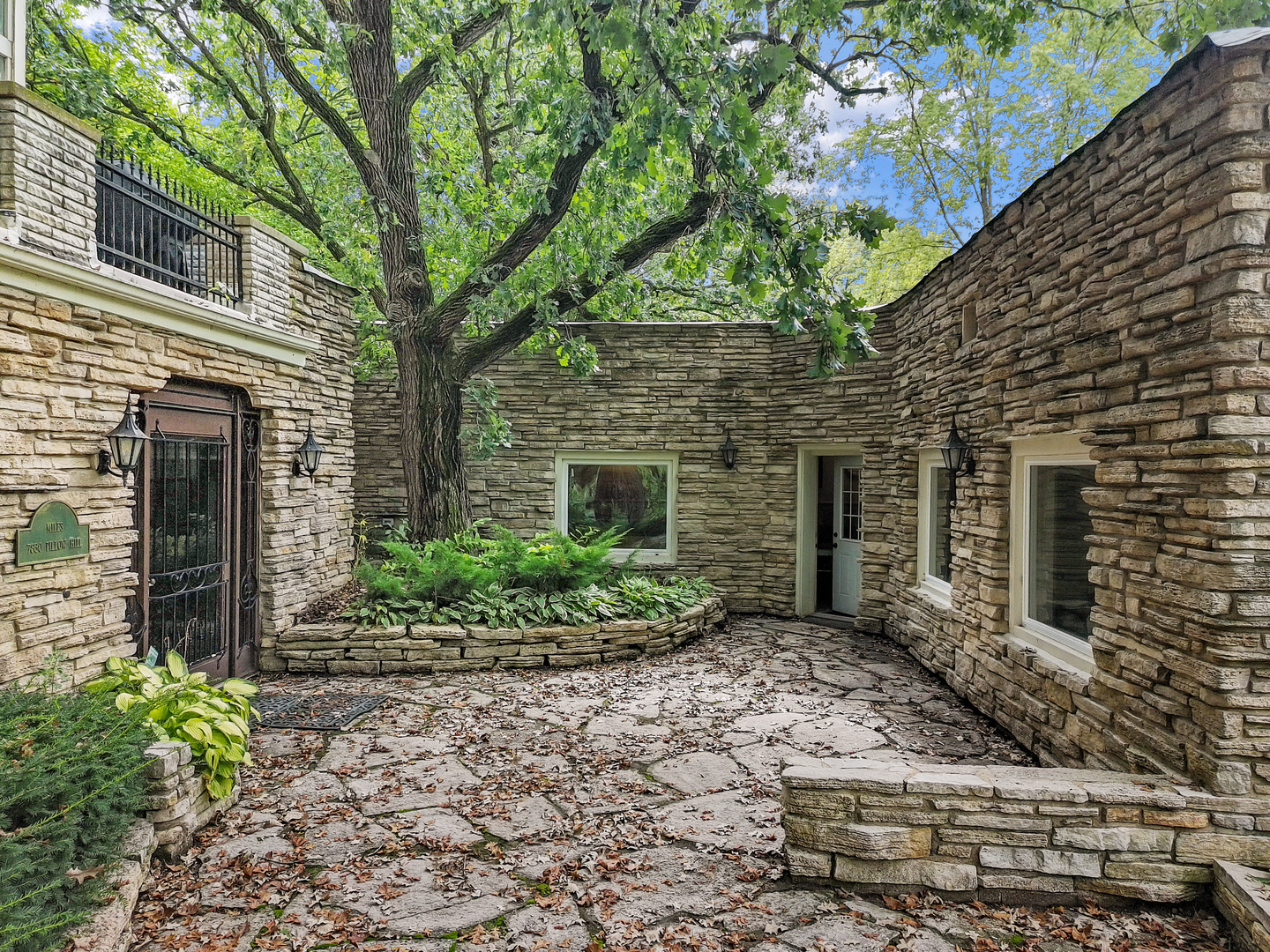 7830 North Pillow Hill Road Spring Grove, IL 60081 - Photo 2 of 69 a view of a brick house with a large windows and large tree