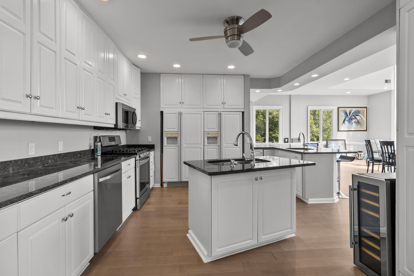7830 North Pillow Hill Road Spring Grove, IL 60081 - Photo 25 of 69 a kitchen with granite countertop a sink stainless steel appliances and white cabinets