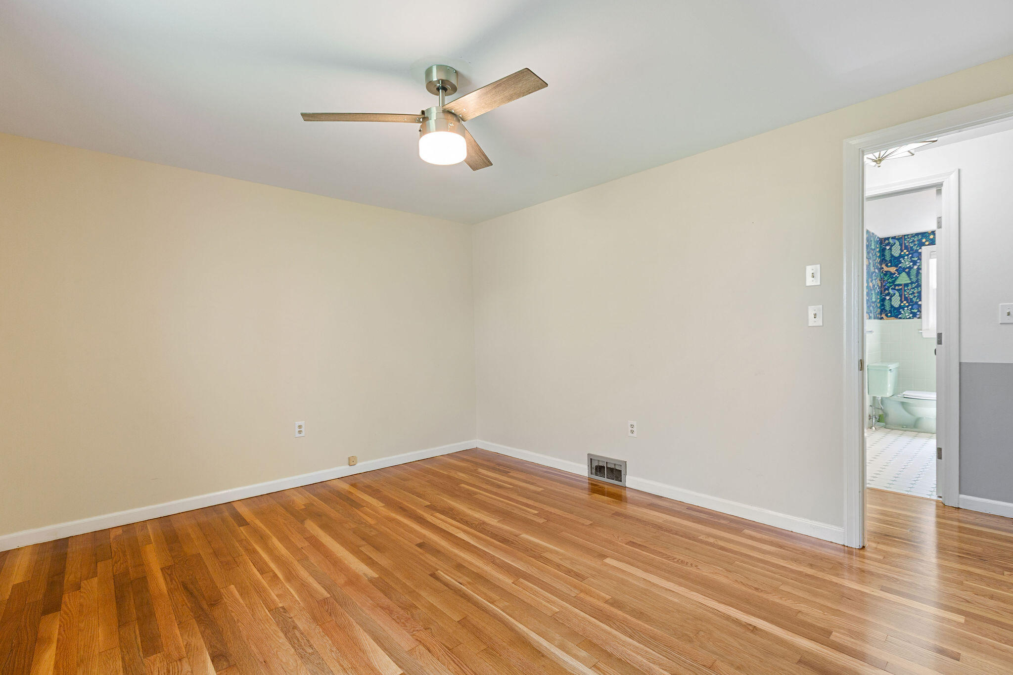 1197 Orleans-Harwich Road Harwich, MA 02645 - Photo 32 of 66 an empty room with wooden floor fan and windows