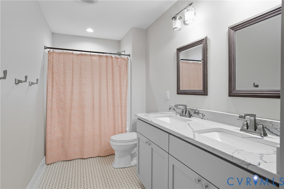 12600 Lerwick Place Chesterfield, VA 23838 - Photo 23 of 47 a bathroom with a sink toilet a mirror and vanity