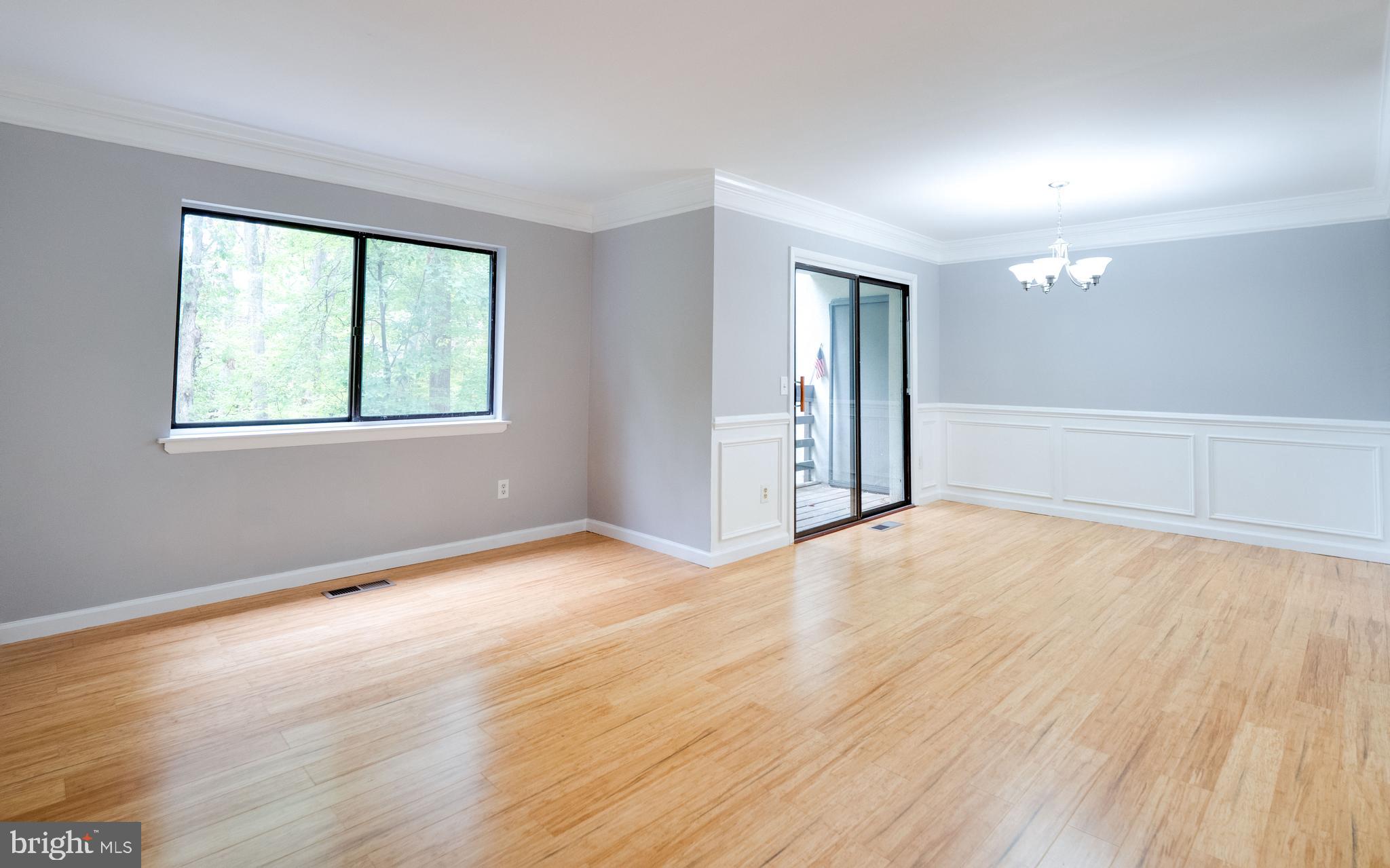 11963 Barrel Cooper Court Reston, VA 20191 - Photo 11 of 33 an empty room with wooden floor and windows