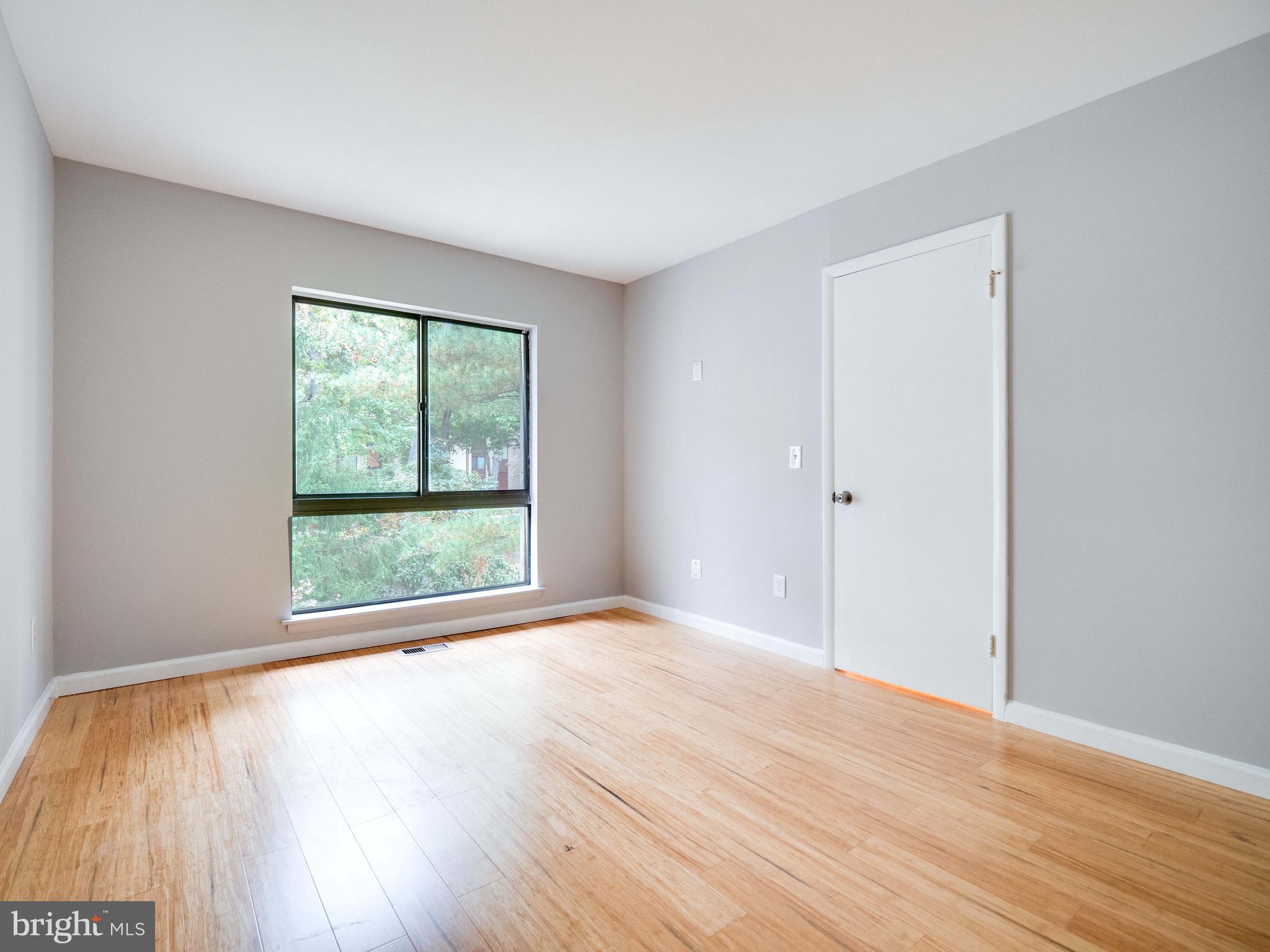 11963 Barrel Cooper Court Reston, VA 20191 - Photo 15 of 33 a view of an empty room with wooden floor and a window