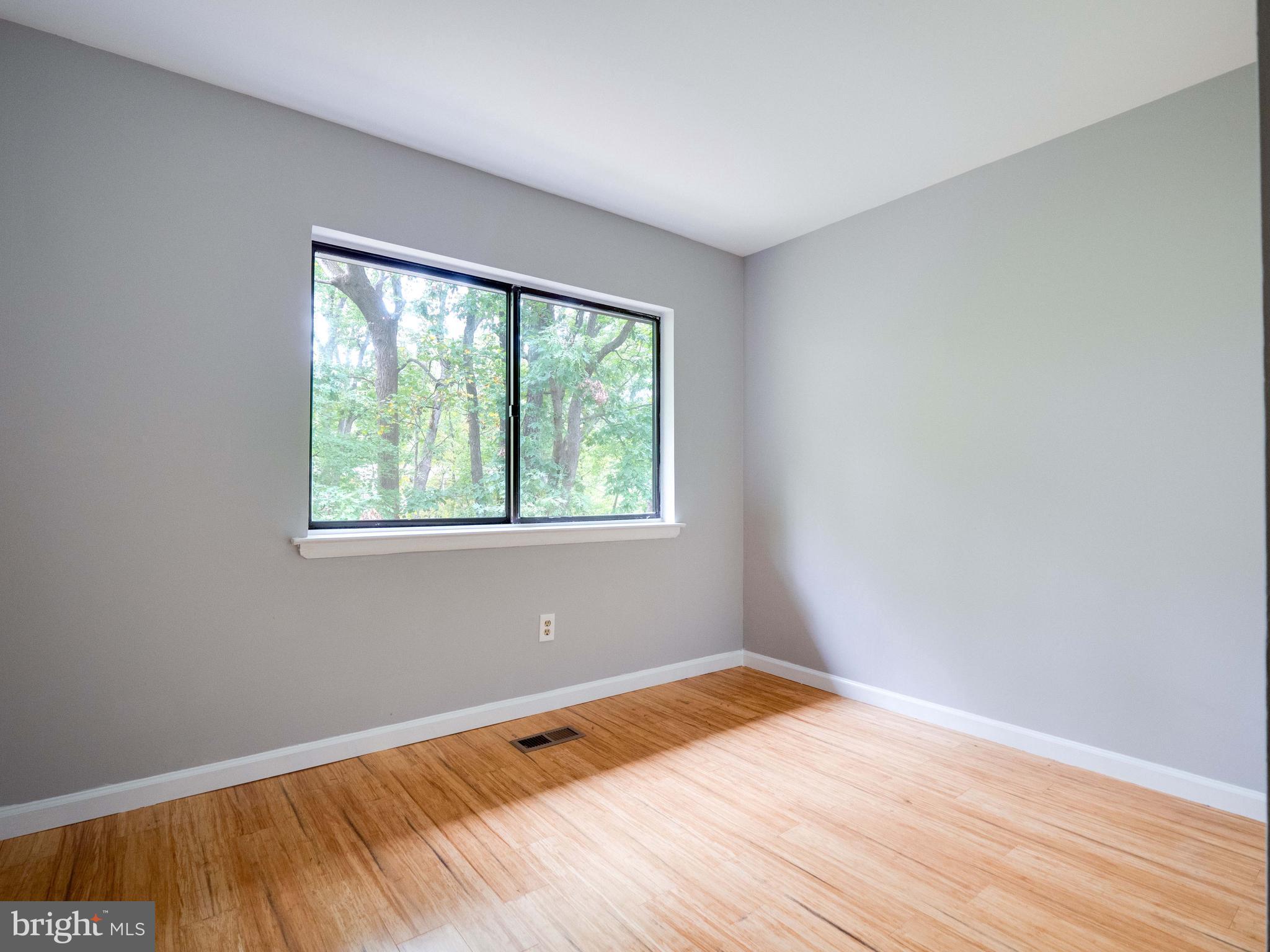 11963 Barrel Cooper Court Reston, VA 20191 - Photo 17 of 33 an empty room with wooden floor and windows