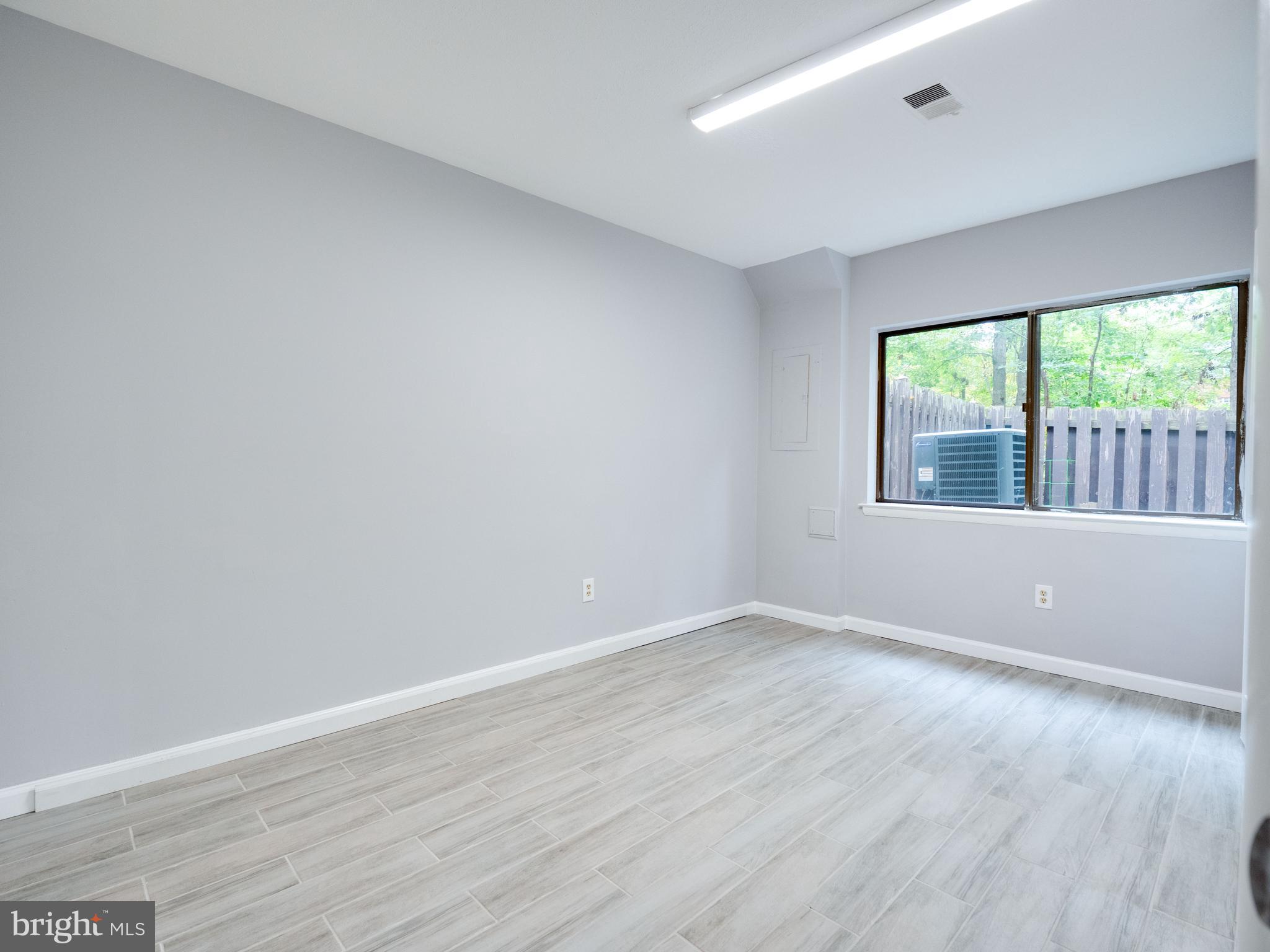11963 Barrel Cooper Court Reston, VA 20191 - Photo 22 of 33 a view of an empty room with wooden floor and a window