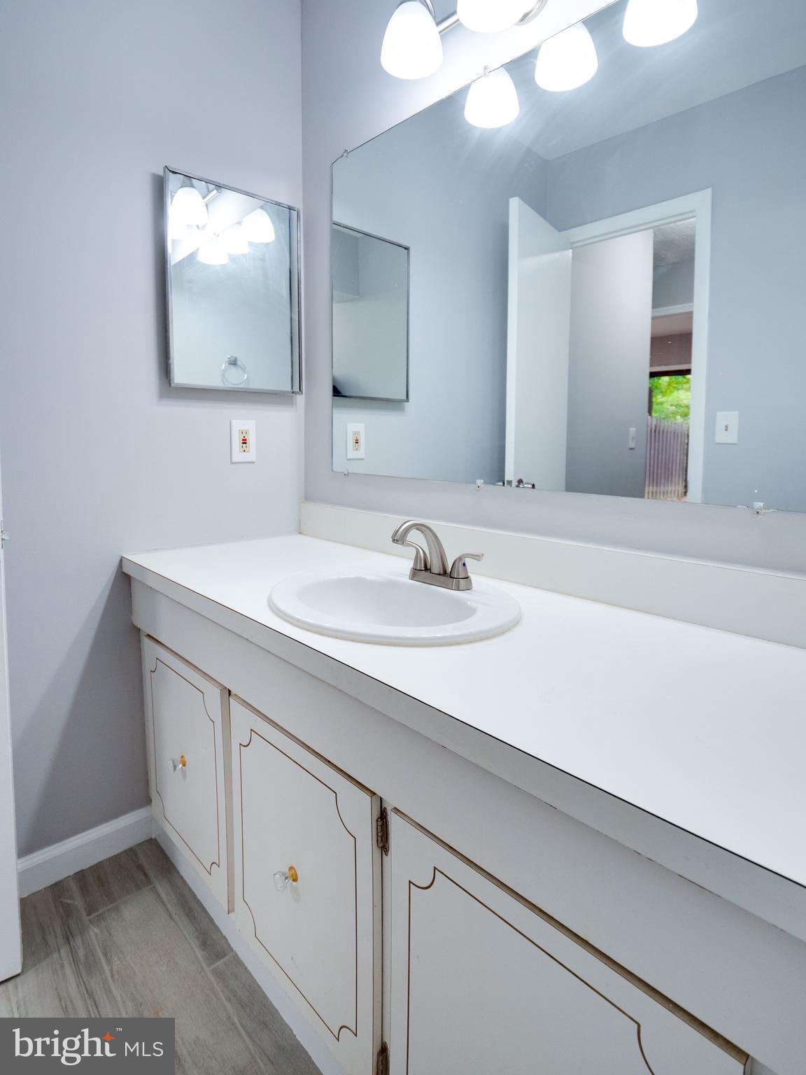 11963 Barrel Cooper Court Reston, VA 20191 - Photo 23 of 33 a bathroom with a sink and a mirror