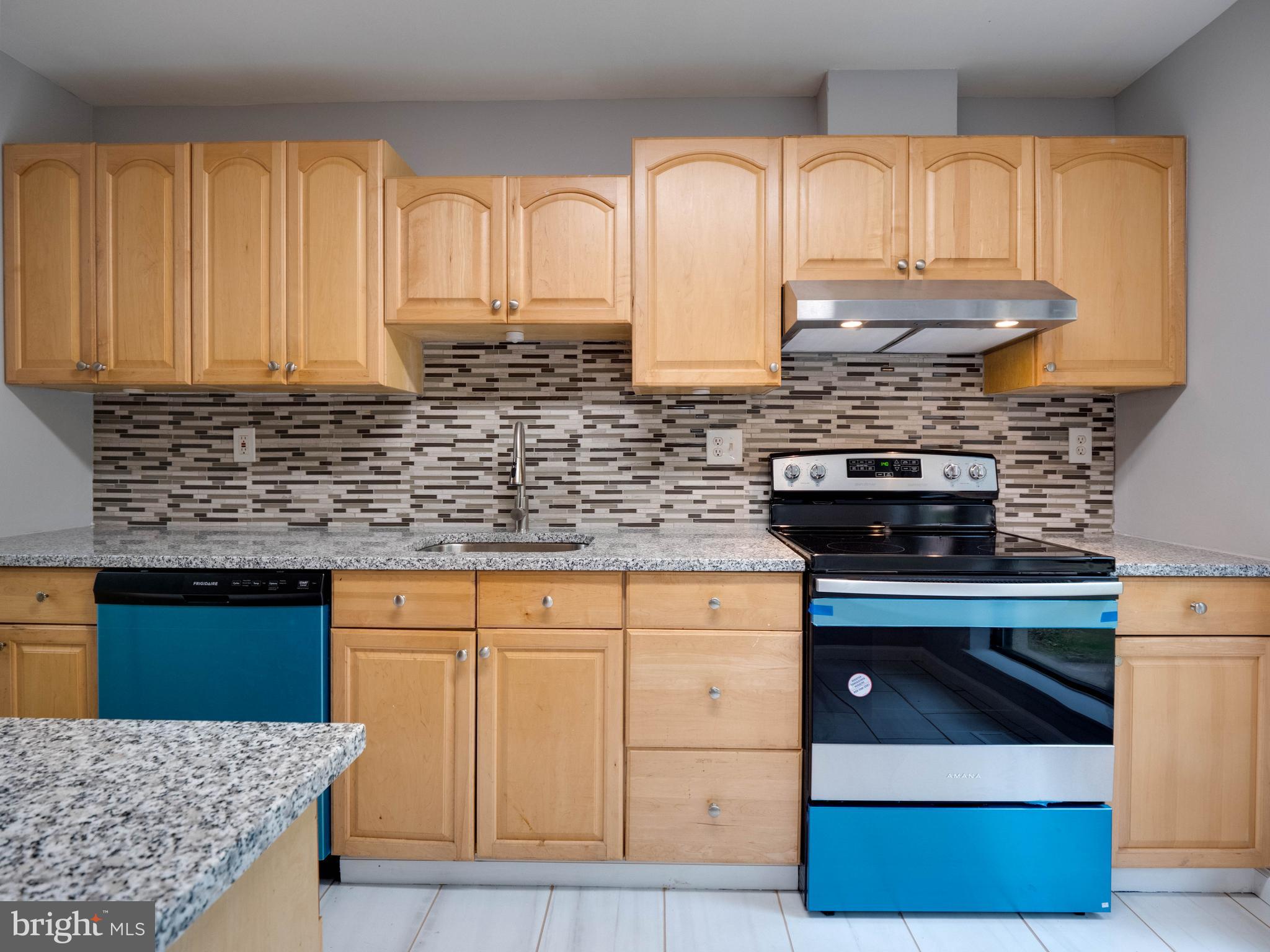 11963 Barrel Cooper Court Reston, VA 20191 - Photo 5 of 33 a kitchen with stainless steel appliances granite countertop a stove a sink and a microwave