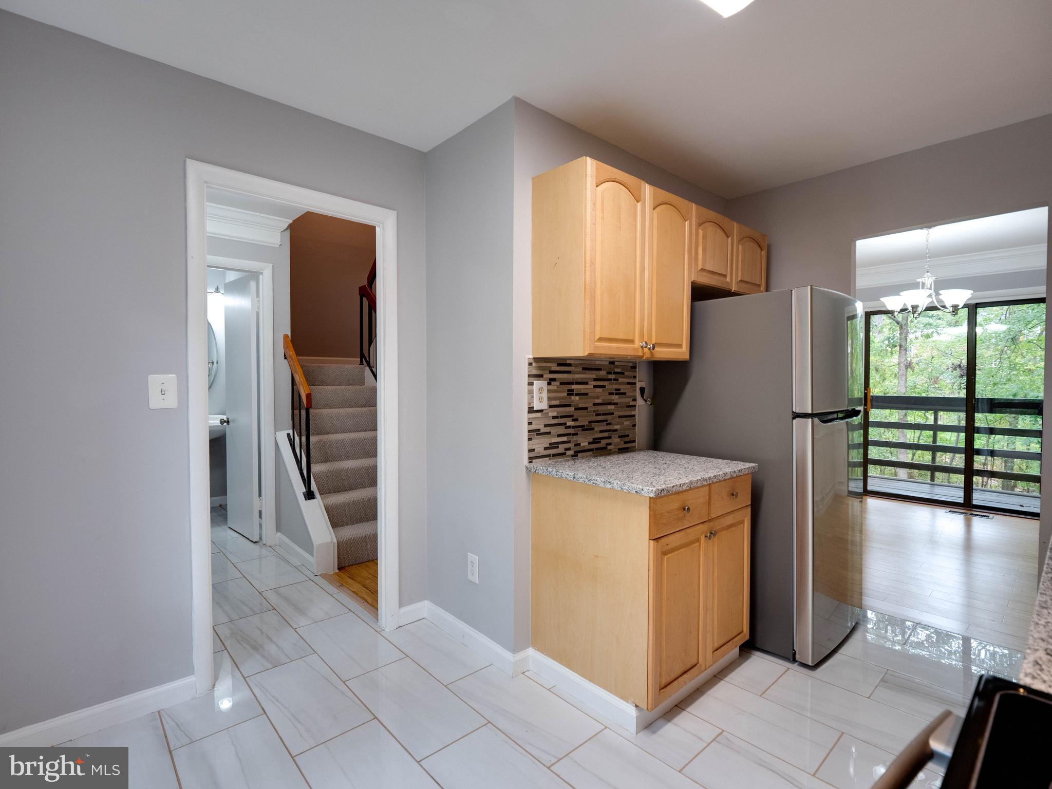 11963 Barrel Cooper Court Reston, VA 20191 - Photo 7 of 33 a kitchen with a refrigerator and a stove top oven