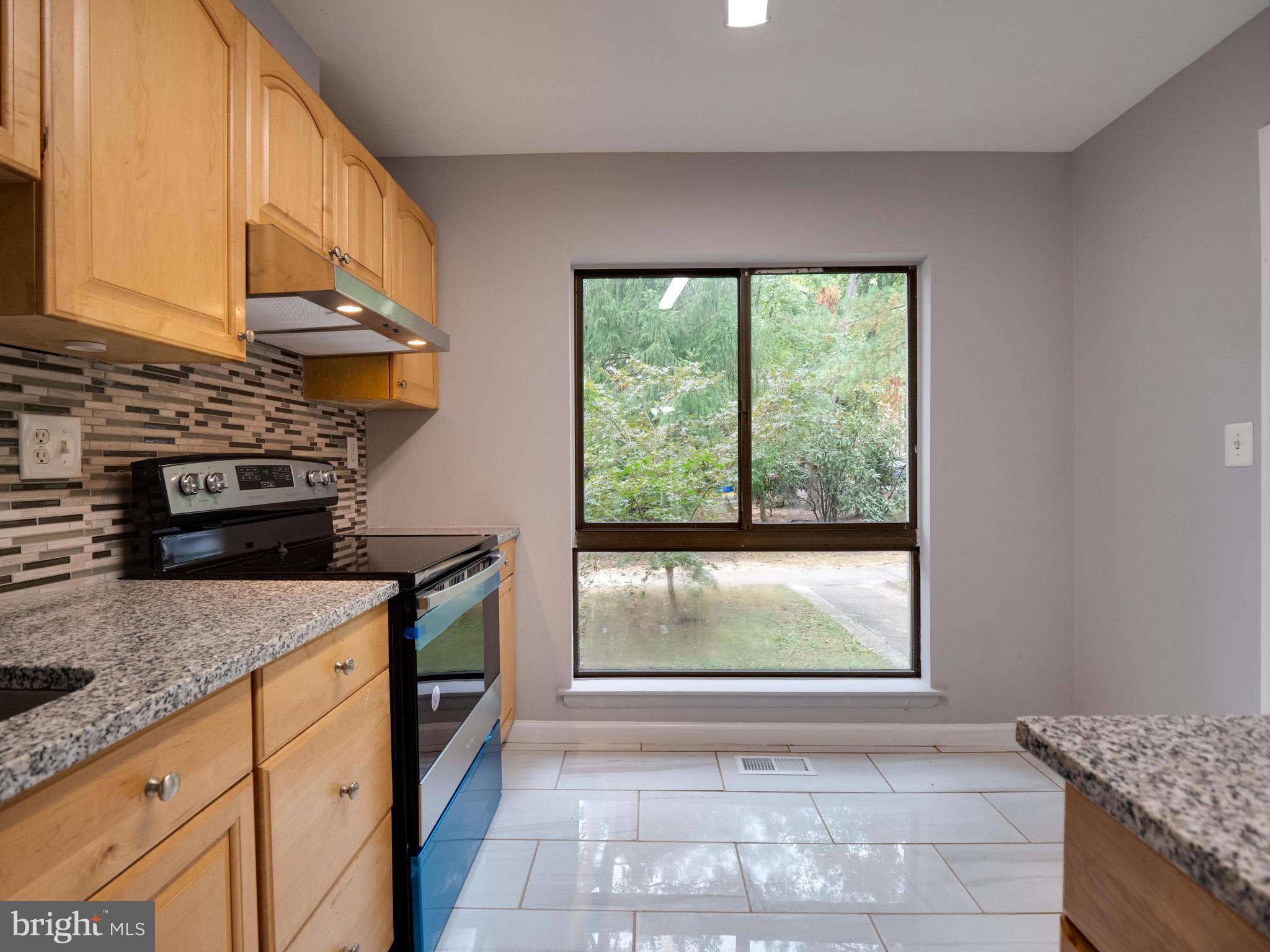 11963 Barrel Cooper Court Reston, VA 20191 - Photo 8 of 33 a kitchen with stainless steel appliances granite countertop a stove a sink and a microwave
