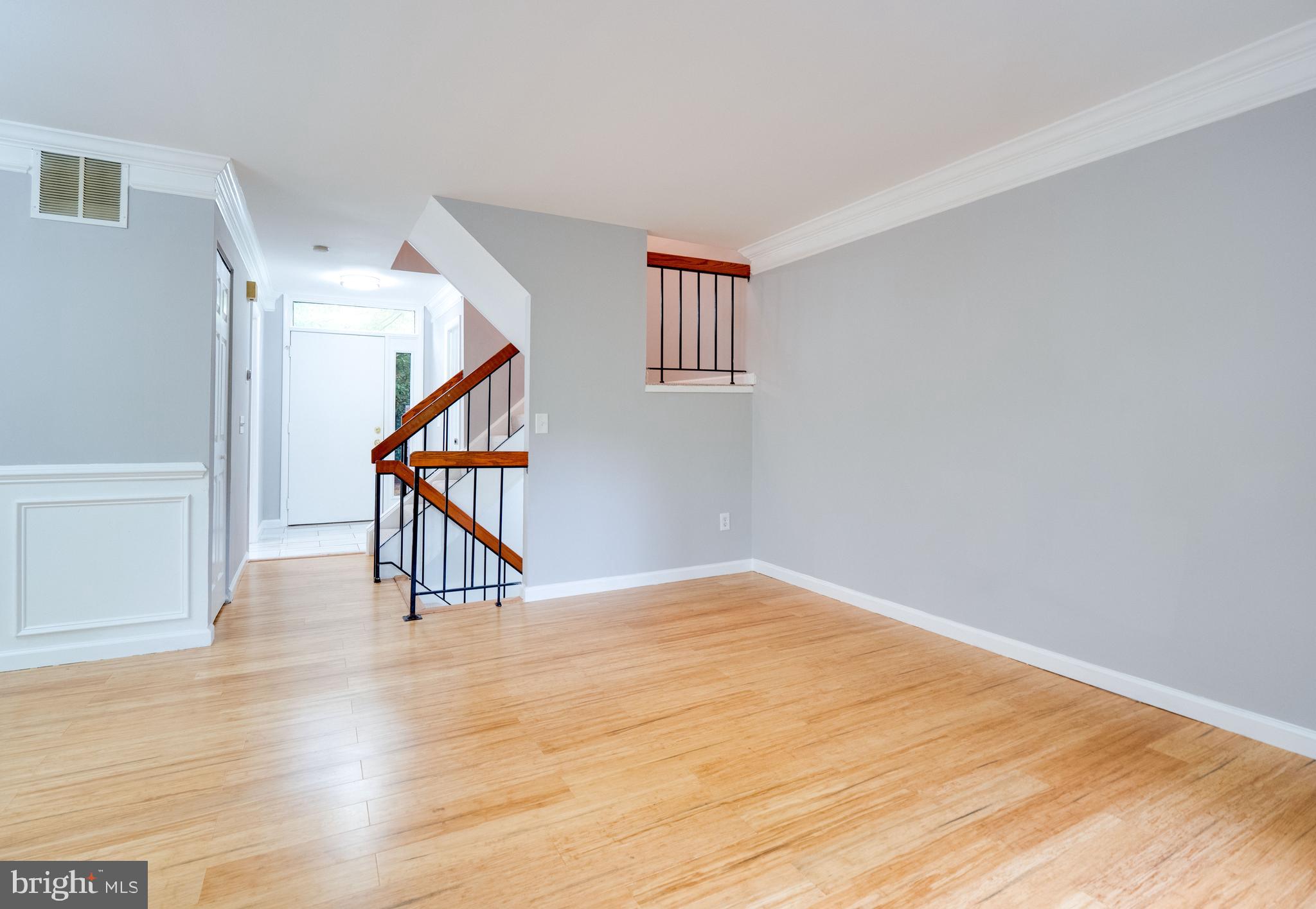 11963 Barrel Cooper Court Reston, VA 20191 - Photo 9 of 33 a view of an empty room with wooden floor and stairs