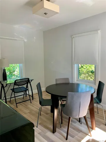 a view of a dining room with furniture and a window