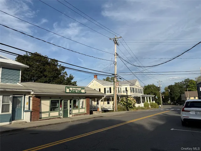 a view of a city street with a car parked on the road