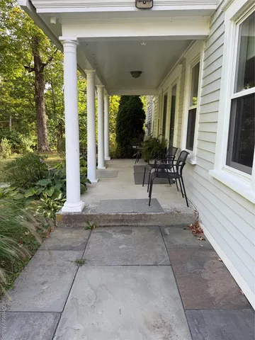 a patio with yard glass top table and chairs