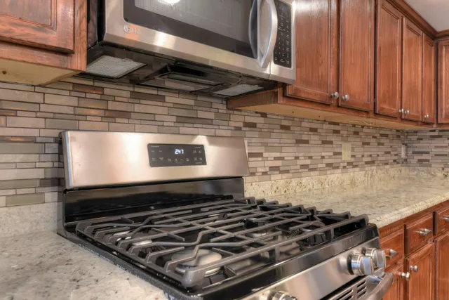 a stove sitting inside of a kitchen
