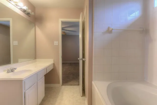 a bathroom with a sink a mirror and a bathtub