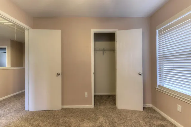 a view of an empty room with a closet